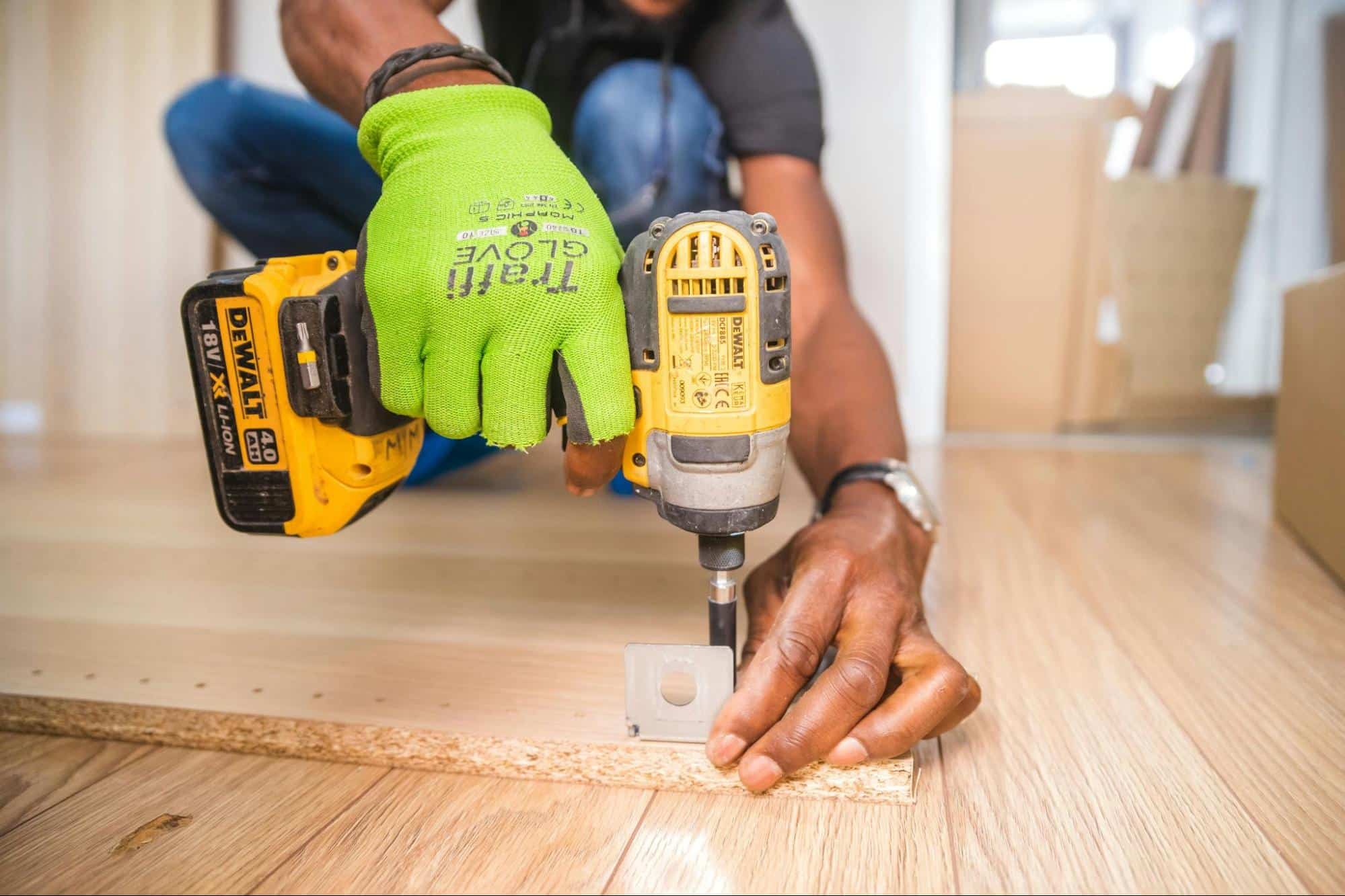 person using cordless impact driver on wood