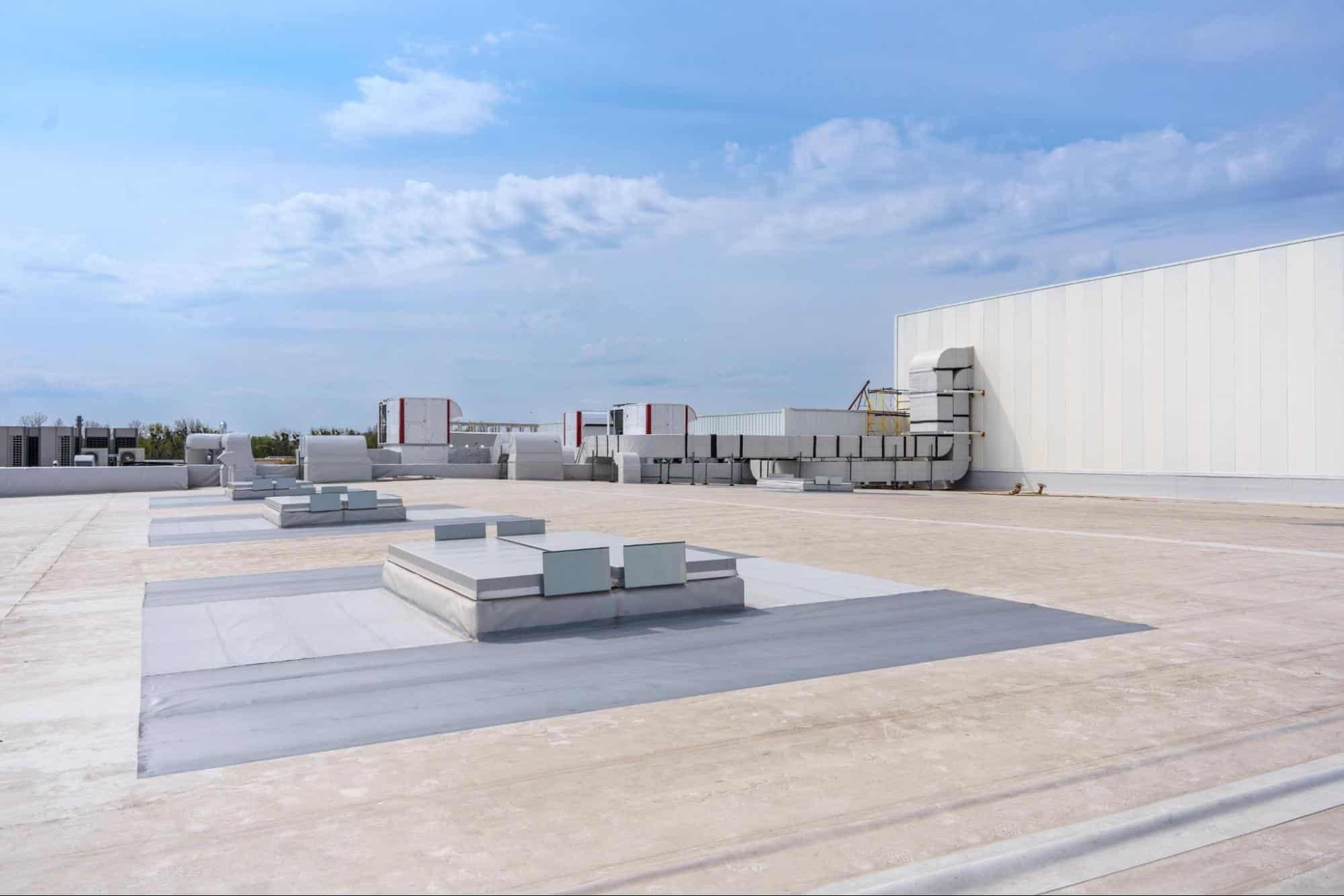 An air conditioning and ventilation system of a large industrial building on the roof, representing industrial roofing solutions for Dallas, TX