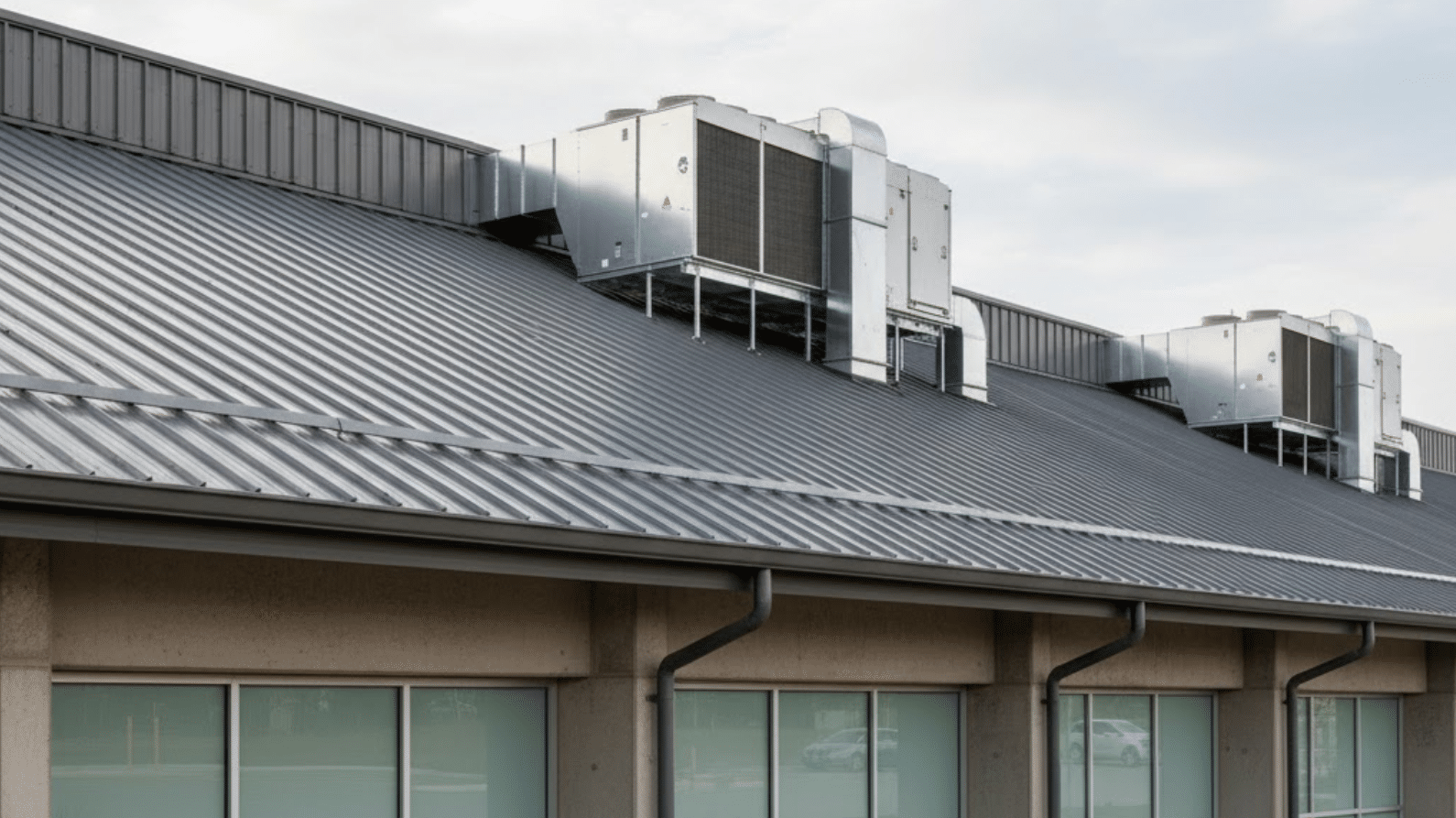 metal-roofed industrial facility with HVAC units installed on top