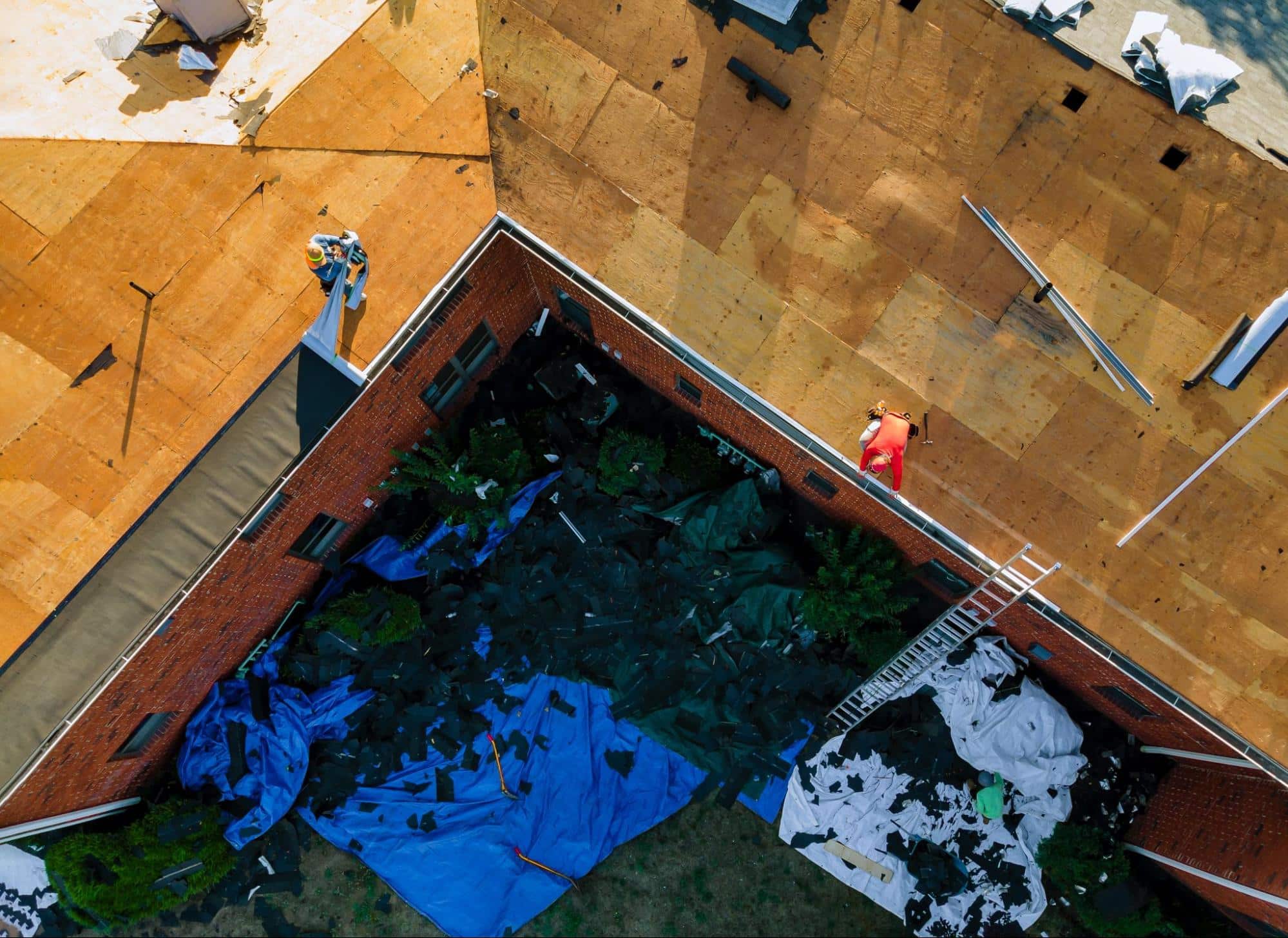 workers repairing a storm-damaged roof