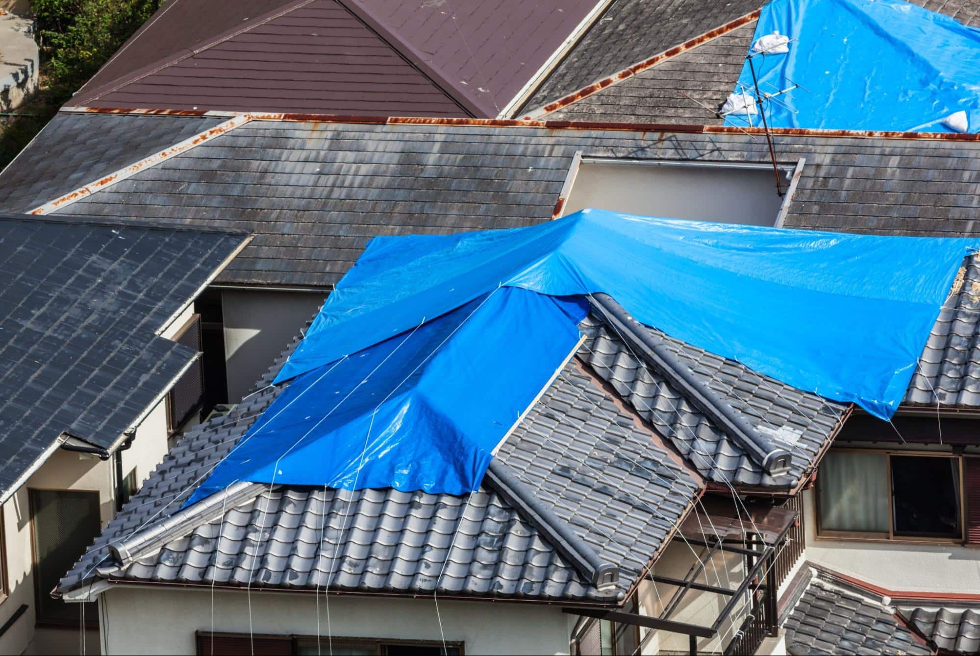 house with damaged tile roof