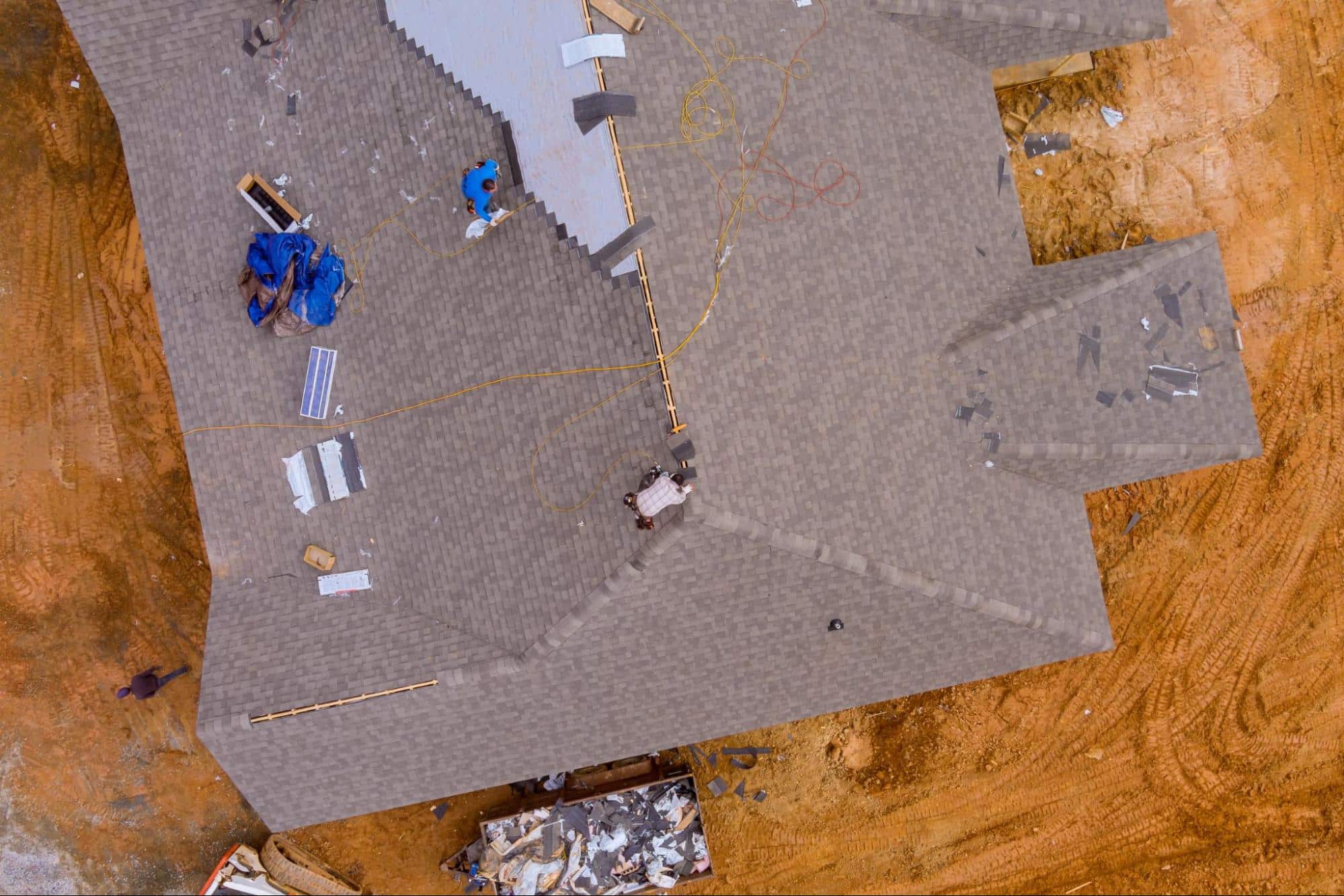 aerial view of roof with some workers, representing the importance of top roofing materials