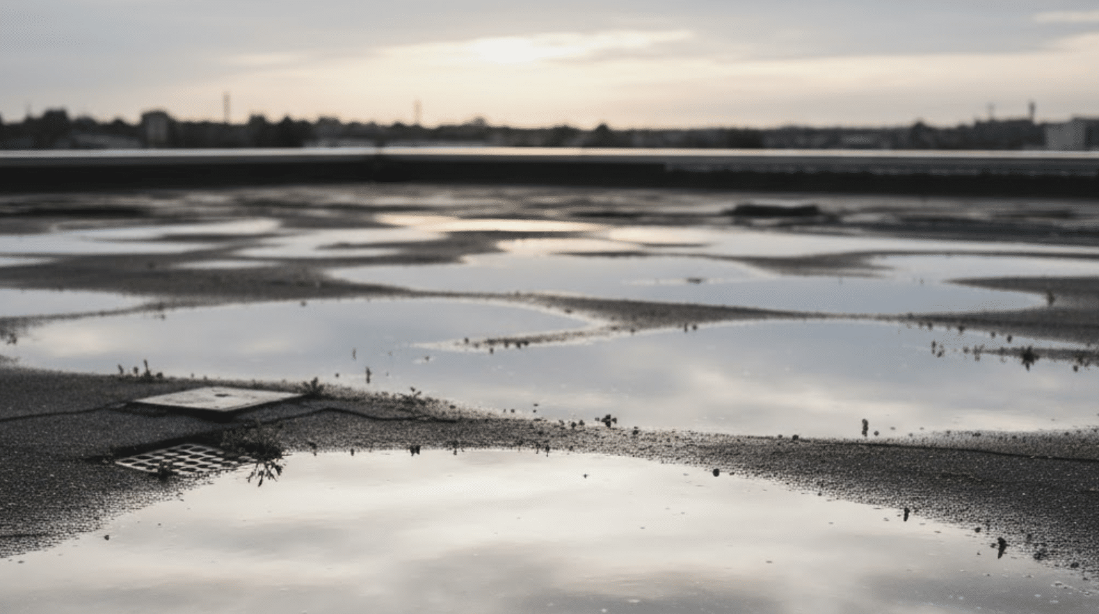 flat roof with small puddles of water after rain